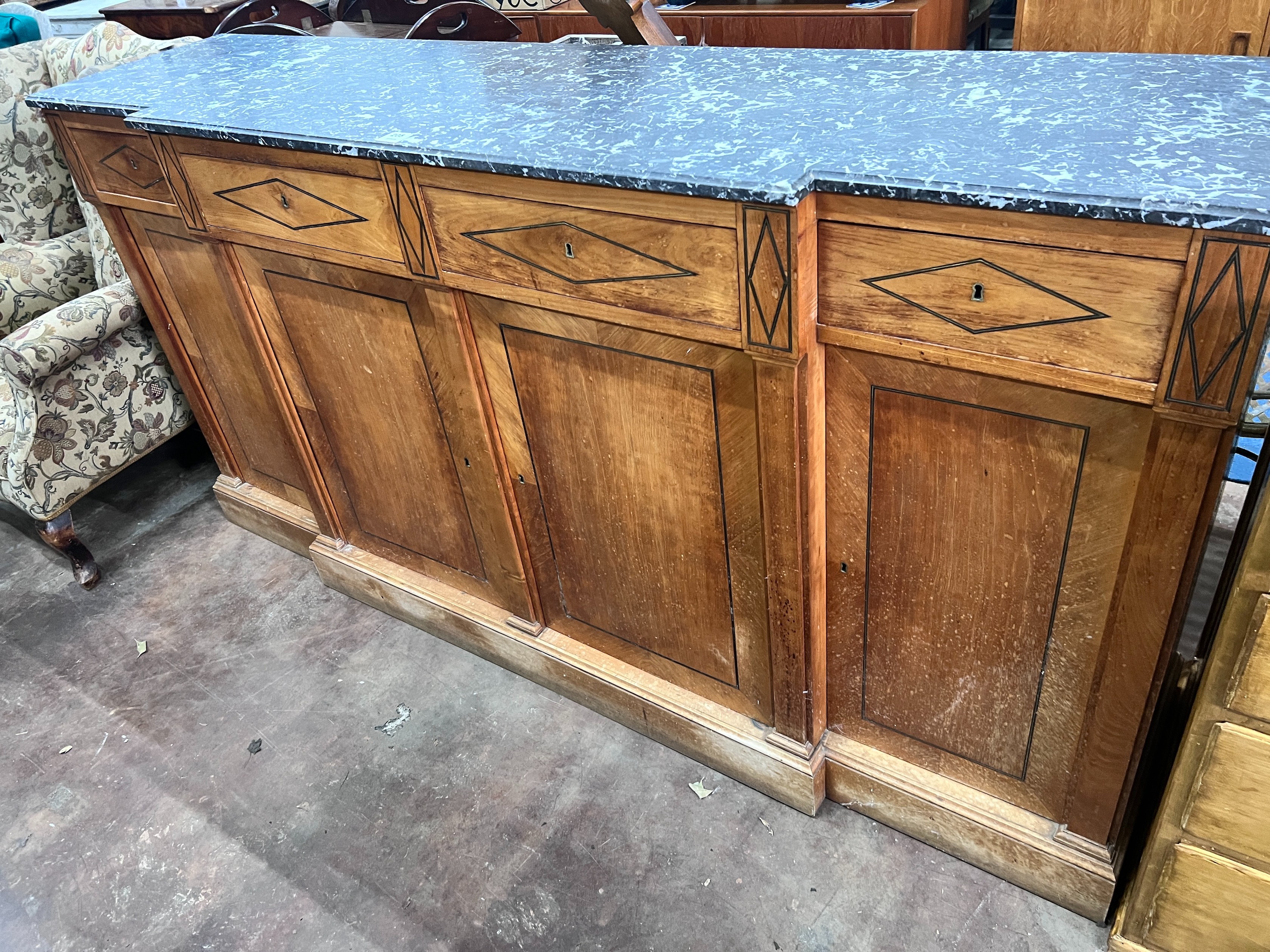 A continental marble topped fruitwood breakfront bookcase, with variegated grey marble top, four drawers and four doors, width 207cm, height 103cm *Please note the sale commences at 9am.